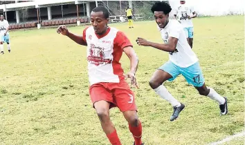  ?? PHOTO BY KAVARLY ARNOLD ?? Nickardo Mairs of Beaches Negril (left) chased for the ball by Jelani Nicholas of Faulkland FC in their JFF Western Confederat­ion/Charley’s JB Rum Super League encounter at Jarrett Park on Sunday. Faulkland won 1-0.