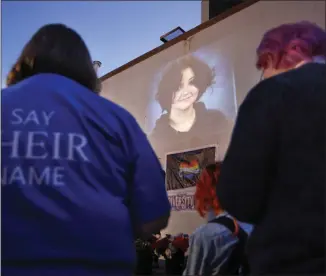  ?? NATE BILLINGS — THE OKLAHOMAN VIA AP ?? A photograph of Nex Benedict, a nonbinary teenager who died a day after a fight in a high school bathroom, is projected during a candleligh­t service at Point A Gallery on Feb. 24in Oklahoma City.