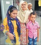  ?? HT PHOTO ?? Kashmir Kaur, mother of late Havildar Hardeep Singh, with his children at Harike Pattan in Tarn Taran on Monday.