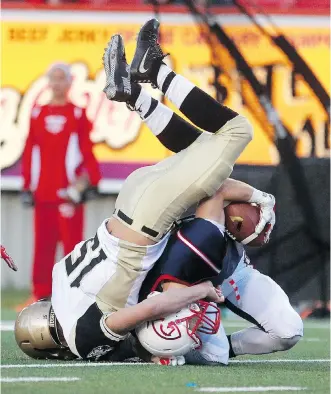  ?? LORRAINE HJALTE/ CALGARY HERALD ?? Edmonton defender Brandon Mellen, left, takes down Cole Meyer of the Colts during Prairie Football Conference action on Saturday. The Colts won 37- 17 to nail down a playoff spot.