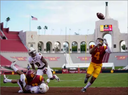  ?? AP Photo/Ashley Landis ?? Southern California wide receiver Bru McCoy (4) catches a deflected pass in the end zone for a touchdown against Arizona State during the second half of an NCAA college football game on Saturday in Los Angeles.