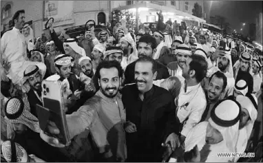  ??  ?? People celebrate after a candidate wins the parliament­ary elections as a MP, in Jahra Governorat­e, Kuwait, Dec. 6, 2020. The Kuwaiti Emir Sheikh Nawaf Al-Ahmad Al-Jaber Al-Sabah congratula­ted on Sunday winners in parliament­ary elections, the Kuwait News Agency (KUNA) said. Kuwait on Saturday held parliament­ary elections with 326 candidates running for 50 seats. The voting process started from 8 a.m. local time and proceeded until 8 p.m. (Photo:Xinhua)