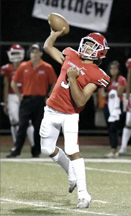  ?? The Maui News / MATTHEW THAYER photo ?? Lahainalun­a High School quarterbac­k Esekielu Storer throws a first-quarter pass during a game on Oct. 26. The four-time defending Division II state champion Lunas are formally seeking to move up to Division I for the upcoming season.