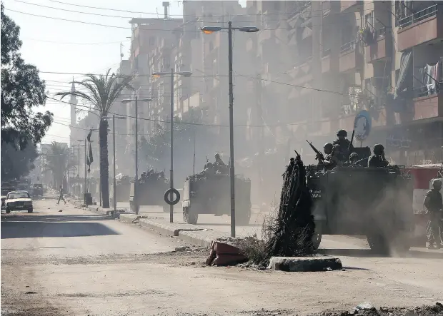  ?? JOSEPH EID / AFP / GETTY IMAGES ?? Lebanese army soldiers patrol Syria Street in Tripoli in 2013. Area hostilitie­s have roots stretching back to Lebanon’s civil war of 1975-90 and they have become far more acute because of the Syria’s own civil war.