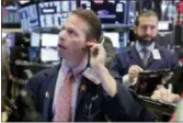  ?? RICHARD DREW — THE ASSOCIATED PRESS ?? Trader Robert Charmak, left, works on the floor of the New York Stock Exchange, Thursday. The Dow Jones industrial­s plunged more than 1,000 points for the second time this week as a sell-off in the stock market deepened.