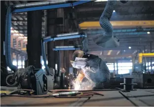  ?? CHINA DAILY VIA REUTERS ?? An employee works on a steel processing production line at a factory in Hefei, Anhui province, China.