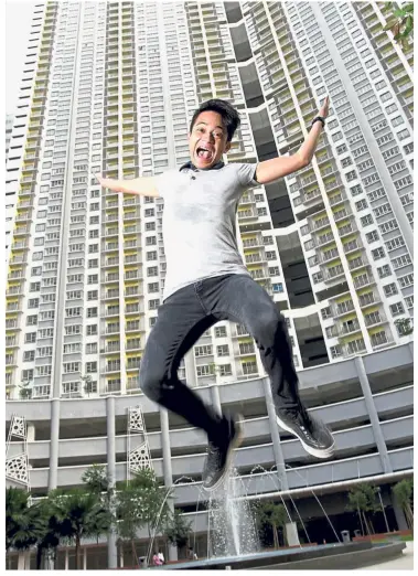  ??  ?? Happy homeowner: Mohamed Syafiq jumping for joy as he now owns an apartment he can call home.