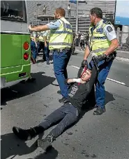  ?? PHOTO: KEVIN STENT/STUFF ?? Protester Rei-marata Goddard said he had trouble breathing as police dragged him away from an approachin­g bus.
