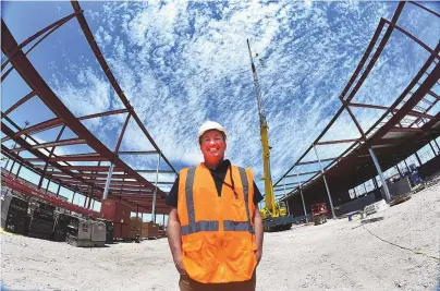  ?? BLAKE OVARD/HOBBS NEWS-SUN ?? Zeke Kaney, current Hobbs Municipal Schools Director of Operations, and newly named director of career and technical education, stands between the two wings of a new learning facility under constructi­on in Hobbs on April 23. When completed, officials say the Hobbs Career and Technical Education Center, or CTECH, will be the premiere vocational education facility of its kind in the region.