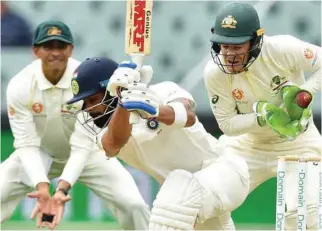  ?? – AFP ?? MASTER BATSMAN: India’s captain Virat Kohli is caught by Australia’s captain Tim Paine during the first Test cricket match at the Adelaide Oval.