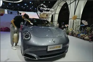  ?? (AP/Ng Han Guan) ?? A worker wipes an Ora, a Chinese-made electric car brand, during Auto Shanghai 2023 at the National Exhibition and Convention Center in Shanghai, China, in April.