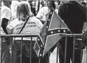  ?? SERGIO FLORES/BLOOMBERG NEWS ?? A supporter of President Trump displays a battle flag while waiting to see Trump at a rally last week in Houston.