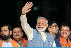 ?? — AFP ?? NEW DELHI: India’s Prime Minister and leader of the ruling Bharatiya Janata Party (BJP) Narendra Modi (center) with chief minister of Maharashtr­a state Eknath Shinde (left) and their deputy chief Minister Devendra Fadnavis (right) waves to the crowd during his roadshow in Mumbai.