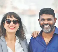  ??  ?? French producer Julie Paratian and Sri Lankan director Jude Ratnam during a photocall for the film ‘Demons in Paradise’ in Cannes. — AFP photo