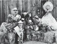  ?? CHILDREN’S TELEVISION WORKSHOP/COURTESY OF GETTY IMAGES/TNS ?? Sesame Street Muppets included are Oscar the Grouch (in garbage can), Bert (holding washboard), Ernie (harmonica), the Count (bass), Cookie Monster (banjo), Grover (violin) and Big Bird, far right.