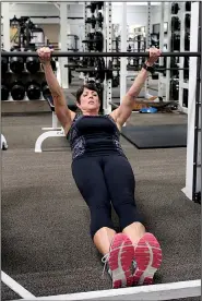  ??  ?? Susan Garrett does the Shoulder Retraction Pull-up, a simple way of tightening important postural muscles.