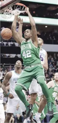  ?? AP ?? Al Horford, de los Celtics de Boston, realiza un donqueo sobre Nicolas Batum, de los Hornets de Charlotte, en acción del partido de ayer en el baloncesto de la NBA.