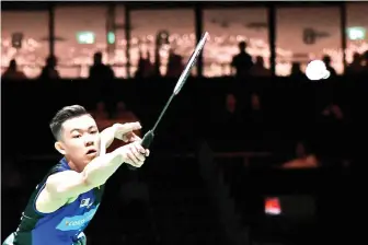  ??  ?? Lee Zii Jia returns the shuttlecoc­k during his men’s singles quarter-final match against Japan’s Kento Momota. - AFP photo