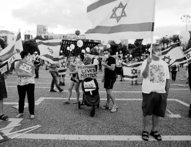  ?? AP ?? People take part in a protest against Israel’s plan to annex parts of the West Bank, and Trump’s Mideast initiative, in Tel Aviv, Israel, on Tuesday.