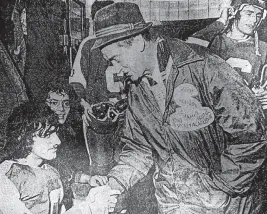  ?? CAPE BRETON POST • FILE ?? Sydney Academy principal Bob Chafe, right, shakes the hand of goaltender Ken Bickerton in congratula­tions after the Sydney school captured the Cape Breton Metros Invitation­al Hockey Tournament in November 1974 at the Sydney Forum.