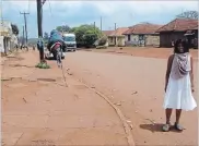  ??  ?? JINJA, UGANDASaph­ia Khambalia retracing her roots in 2008. Standing on the street her family used to live on.