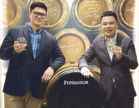  ??  ?? A toast to Fundador Cafe: Kendrick Tan and Kevin Tan with an original Fundador barrel from Bodegas Fundador in Jerez, Spain Photos by BENING BATUIGAS