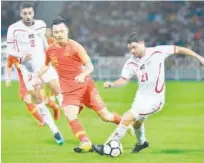  ?? Agence France-presse ?? Palestine’s Alexis Patricio Norambuena (right) competes for the ball with China’s Gao Lin during their friendly match on Tuesday.