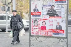  ??  ?? ELECTION DAY: People walk past election posters in Yerevan earlier this week, days before parliament­ary elections.