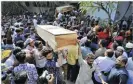  ??  ?? AFP Relatives carry coffins of victims of the deadly fire which tore through apartment blocks in Bangladesh’s capital Dhaka.