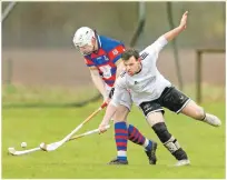  ??  ?? Lovat’s Greg Matheson fight or the ball with Kingussie’sRory MacKeachan.