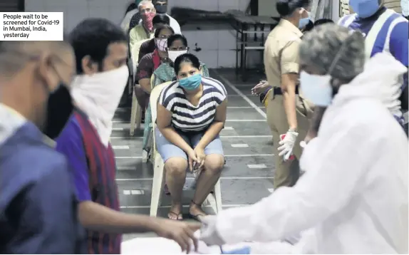  ??  ?? People wait to be screened for Covid-19 in Mumbai, India, yesterday