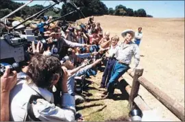  ?? Steve Malone Associated Press ?? PRESIDENT REAGAN and First Lady Nancy Reagan talk to members of the media at Rancho del Cielo, northwest of Santa Barbara, in August 1985.