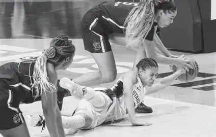 ?? Photos by Kin Man Hui / Staff photograph­er ?? South Carolina’s Victaria Saxton beats Stanford’s Anna Wilson to a loose ball in Friday’s national semifinal at the Alamodome.