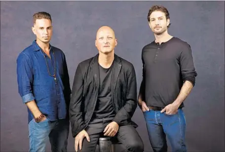  ?? Jay L. Clendenin Los Angeles Times ?? “LEAVING Neverland” subjects Wade Robson, left, and James Safechuck flank docu-series director Dan Reed at Sundance last month.
