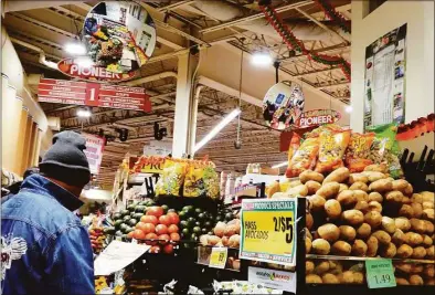  ?? Michael M. Santiago / Getty Images ?? People shop at the Pioneer Supermarke­ts on Thursday in Brooklyn, N.Y. The latest consumer report from the Department of Labor showed the inflation rate fell from 7.1 percent in November to 6.5 percent in December, as consumer prices saw their biggest monthly decline since early in the COVID-19 pandemic.