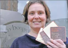  ??  ?? Lucy Hunt from The Dove Centre with Absent Friends drink mats going on tables at reminiscen­ce cafes in Oban.