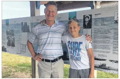  ?? SUBMITTED PHOTO/OLIVER ENGEL ?? Oliver Engel, left, with his son Lars, in front of the recently installed informatio­n panels describing the myth of the sunken German U-boat off the coast of North Cape.