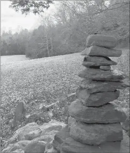 ??  ?? A cairn created by past visitors to the Torrey Preserve sits on a rock along the edge of a farm field.
