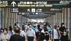  ?? ISSEI KATO / REUTERS ?? Mask-wearing commuters remain on guard against COVID-19 at a train station in Nagoya, Japan, on Thursday.