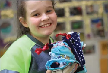  ??  ?? Emily Kelly admiring some ‘Worry Friends’ and hand-sewn bags.