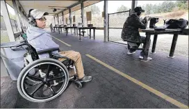  ?? CURTIS COMPTON / CCOMPTON@AJC.COM ?? Department of Natural Resources range safety officer Chip Madren, 20, works at the Clybel Shooting Range at the Charlie Elliott Wildlife Center in Mansfield. Madren, a cancer survivor, began working with the DNR earlier this year to help make public...