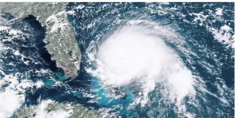  ?? FOTO: GOES-16-SATELLIT/NOAA/DPA ?? Hurrikan „Dorian“bewegt sich über offene Gewässer im Atlantik, links oben ist die Halbinsel Florida zu sehen.