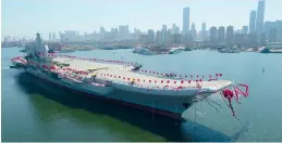  ?? — AP ?? The newly-built aircraft carrier is transferre­d from the dock into the water at a launch ceremony at a shipyard in Dalian, in China’s Liaoning province, on Wednesday.