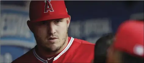  ?? AP PHOTO/TONY DEJAK ?? Los Angeles Angels’ Mike Trout stands in the dugout during the third inning of a baseball game against the Cleveland Indians, on Saturday, in Cleveland.