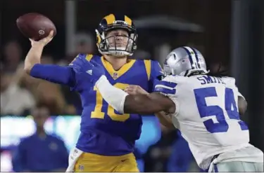  ?? MARK J. TERRILL — THE ASSOCIATED PRESS ?? Rams quarterbac­k Jared Goff passes under pressure from Cowboys middle linebacker Jaylon Smith on Jan. 12 in Los Angeles. The Rams play at New Orleans in the NFC title game.