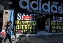  ?? AGUSTÍN MARCARIÁN / REUTERS ?? Mercados. Ofertas para incentivar las compras en Buenos Aires.