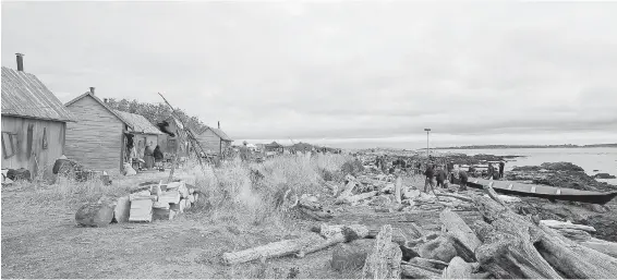  ?? ADRIAN LAM, TIMES COLONIST ?? Oak Bay’s Cattle Point is turned into a village of ancient huts, with barrels, washboards, native paddles and canoes for the filming of Murdoch Mysteries.