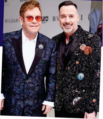  ??  ?? I’m still standing: Sir Elton, who is now back to full health, with his husband David Furnish