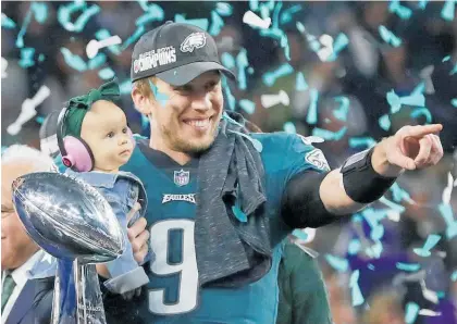  ?? Picture / AP ?? Philadelph­ia Eagles quarterbac­k Nick Foles and his daughter, Lily, celebrate with the Lombardi Trophy.