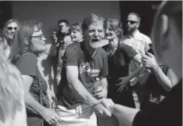  ?? Hyoung Chang, The Denver Post ?? Jack Phillips, owner of Masterpiec­e Cakeshop, meets supporters in his Lakewood shop on June 8.